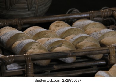 Freshly baked, flour-dusted loaves of bread arranged in rustic woven baskets. Sliced bread in the foreground, creating a warm, artisanal atmosphere with an organic, natural touch. - Powered by Shutterstock