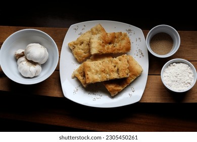 Freshly baked homemade focaccia bread on a white dish.  - Powered by Shutterstock