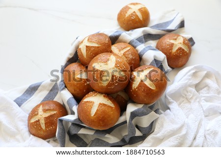 Freshly baked homemade 'Laugenbroetchen' ( German) - Soft Pretzel buns - German bread, homemade baking concept
