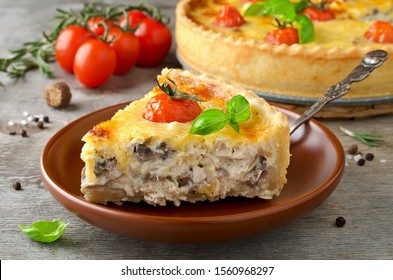 Freshly baked homemade pie quiche Lorraine on a wooden table. Traditional French pastries