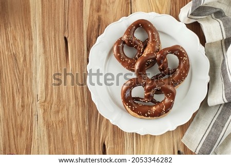 Freshly Baked Homemade Soft Pretzel (Bavarian Brezel) with Salt on Rustic Table. Perfect for Octoberfest. Top View with Copy Space 