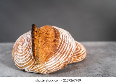 Freshly Baked Loaf Of A Wheat Sourdough Bread With Marks From Bread Proofing Basket.