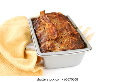 A Freshly Baked Meatloaf In The Pan With Bacon On Top