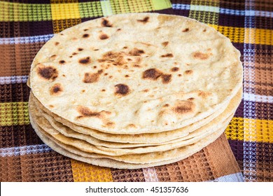 Freshly baked Mexican tortillas laid out on a towel