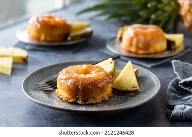 Freshly Baked Mini Pineapple Upside Down Cakes With Caramel Sauce On Top.