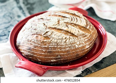 Freshly Baked Organic Sourdough Bread In A Red Dutch Oven