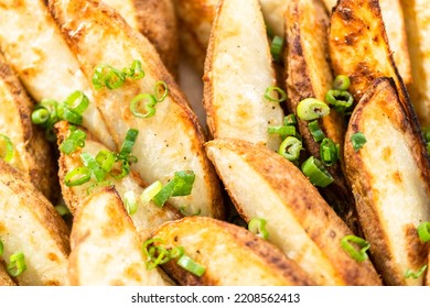 Freshly Baked Potato Wedges With Spices On A White Serving Tray.