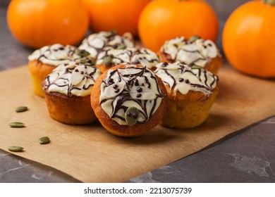 Freshly Baked Pumpkin Muffins Decorated Ghosts, Spiderweb For Halloween Celebration. Autumn Composition With Pumpkins, Cupcakes On Dark Stone Table. Fall Time. Selective Focus. Autumn Dessert.