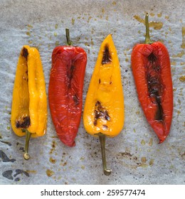 Freshly Baked Red And Yellow Peppers On Baking Paper