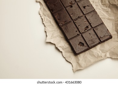 Freshly Baked Rustic Healthy Chocolate Bar With Nuts On Craft Paper, Isolated On White Table On Side, Top View