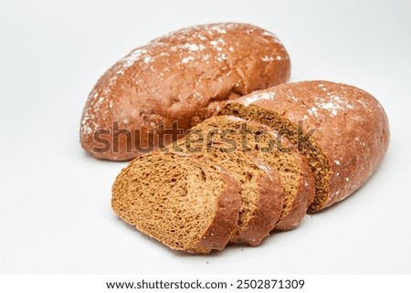 Freshly baked rye bread with a rustic crust, perfect for sandwiches or as a side on white background