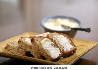 Freshly Baked And Sliced Banana Bread With Butter