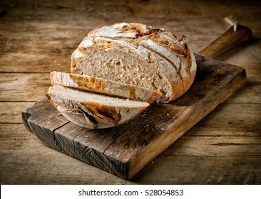 freshly baked sliced bread on rustic wooden table