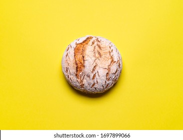 Freshly baked sourdough bread on a yellow seamless background. Wheat loaf without yeast flat lay. Traditional rustic bread. - Powered by Shutterstock