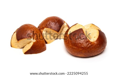 Freshly baked traditional German laugenbrot. Bavarian homemade pretzel rolls lye bread, close-up, isolated on white background.