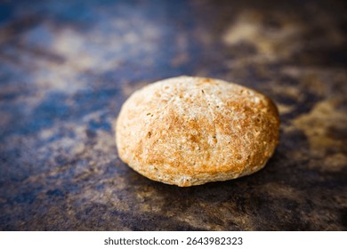 Freshly baked whole grain breakfast rolls from ready-made dough, rustic and hearty, served on a kitchen table. Healthy start to the day with homemade flavor