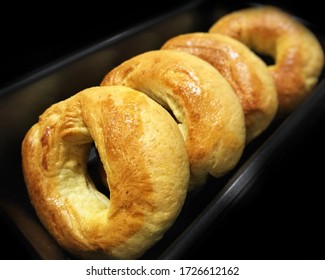 Freshly Baled Cornmeal Bagels In Black Background