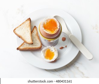 Freshly Boiled Brown Egg On White Plate, Top View