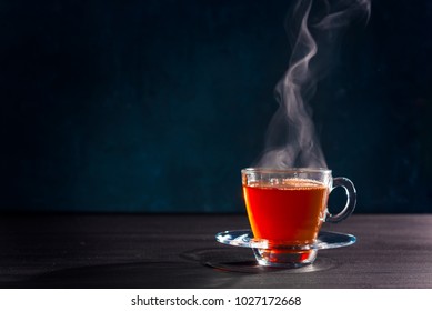 Freshly Brewed Black Tea In A Transparent Glass Cup,escaping Steam,darker Background.