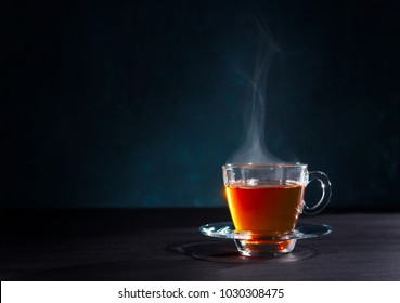 Freshly Brewed Black Tea In A Transparent Glass Cup,escaping Steam,darker Background.