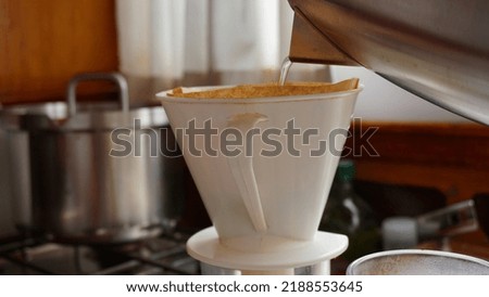 Freshly brewed coffee with a separate filter and pour in water. Fresh morning drink with blackened caffiene to which sugar and milk may have been added. Energy boost.