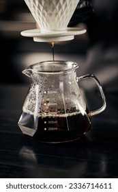freshly brewed espresso dripping into glass pot from ceramic dripper, V-60 style alternative brew - Shutterstock ID 2336714611