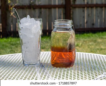 Freshly Brewing Sun Tea Or Sweet Tea In A Mason Jar In The Warm Sunshine Of Summertime.