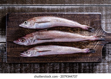 Freshly Caught Whole Silver Hake On A Rustic Wood Table Top.