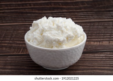 Freshly Churned White Butter Also Known As Safed Makhan Malai Or Homemade Makkhan In India Is Used To Prepare Desi Ghee In White Bowl. Isolated On Brown Wooden Background With Copy Space For Text - Shutterstock ID 1912021225
