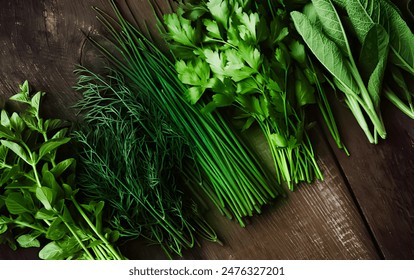 Freshly clliped herbs on wooden background, Various garden herbs on table. Basil, dill, parsley, rosemary. Flat lay, Collection of fresh garden herbs on dark granite table, top view. - Powered by Shutterstock