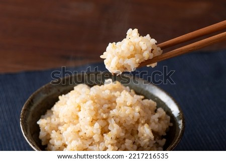 Freshly cooked brown rice, a bowl of Unpolished rice