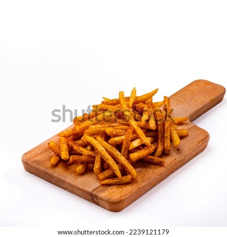 Freshly cooked French fries baked with cheddar cheese, jalapeno and Sauce closeup on a plate. wood background