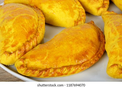 Freshly Cooked Homemade Vegetarian Pasties On A White Plate.