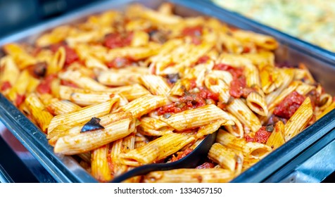 Freshly Cooked Italian Penne Pasta In Bolognese Sauce In A Warming Tray As A Catering Concept.