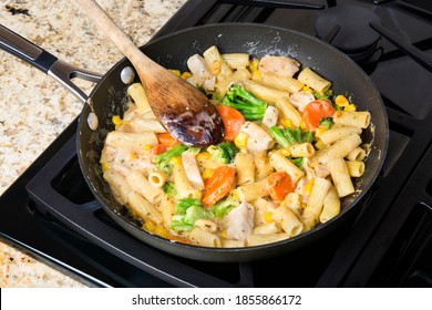 Freshly Cooked Pasta With Vegetables, Chicken And Cream Sauce In A Stove Top Simmering Pan