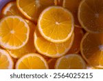 Freshly cut orange slices showcase their juicy segments, adding a splash of color and zest to any gathering.