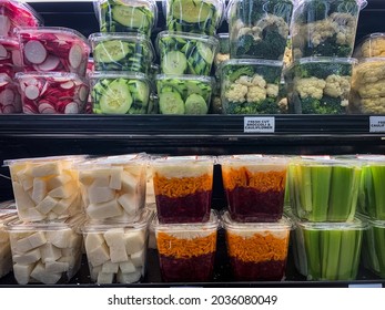 Freshly Cut Veggies In Plastic Containers Arranged On Shelves At Grocery Store 