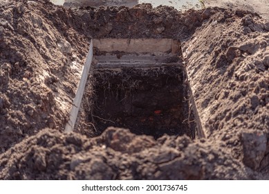 Freshly dug grave pit at cemetery, a close-up. - Shutterstock ID 2001736745