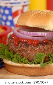 Freshly Grilled Hamburger In A 4th Of July Picnic Setting