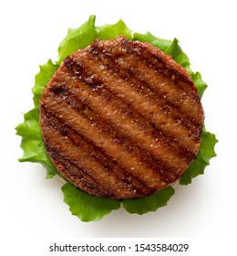 Freshly Grilled Plant Based Burger Patty On Bun With Lettuce Isolated On White. Top View.