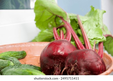 Freshly harvested beetroots with stems, cucumbers, and colorful cherry tomatoes in a rustic bowl, showcasing vibrant, organic produce. - Powered by Shutterstock