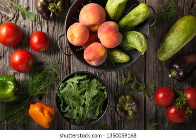 Freshly harvested fruits, vegetables and herbs on a wooden surface.