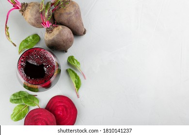 Freshly made beet juice on grey table, flat lay. Space for text
