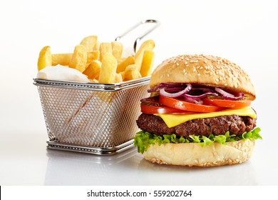 Freshly made cheeseburger with basket of French fries on white background - Powered by Shutterstock