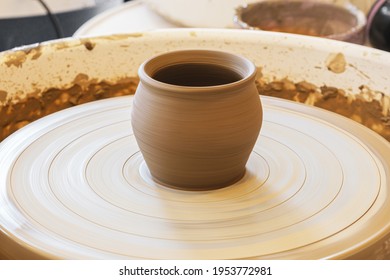 Freshly made clay pot on a potter's wheel. Master class in the pottery workshop. Creative leisure for adults and children. - Powered by Shutterstock