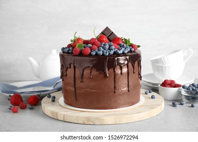 Freshly made delicious chocolate cake decorated with berries on white table