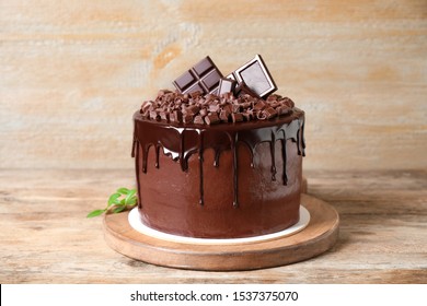 Freshly made delicious chocolate cake on wooden table