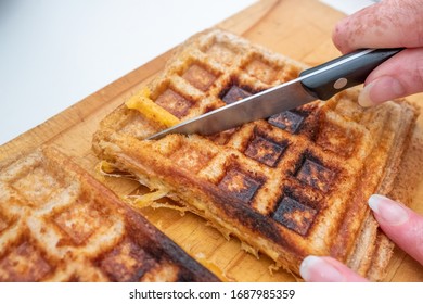 Freshly Made Melted Cheese Sandwhich Being Sliced On A Bread Board