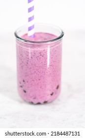 Freshly Made Mixed Berry Boba Smoothie In A Drinking Jar With Paper Straw.