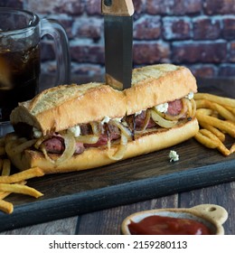 Freshly Made Steak Hoagie Bun With Blue Cheese And Onions, Served With Fries.